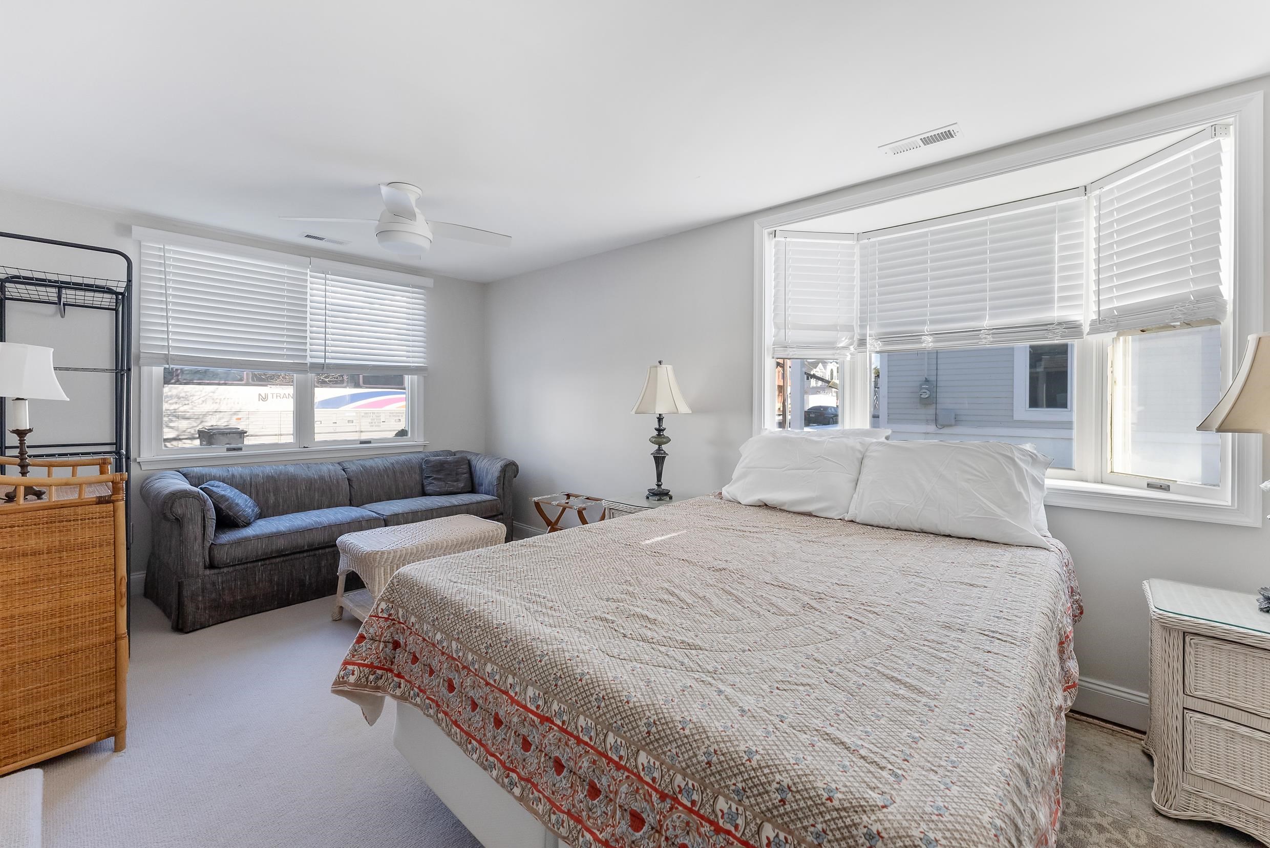 274 52nd Street Avalon, NJ 08202 - Photo 31 of 39 a spacious bedroom with a bed and a couch