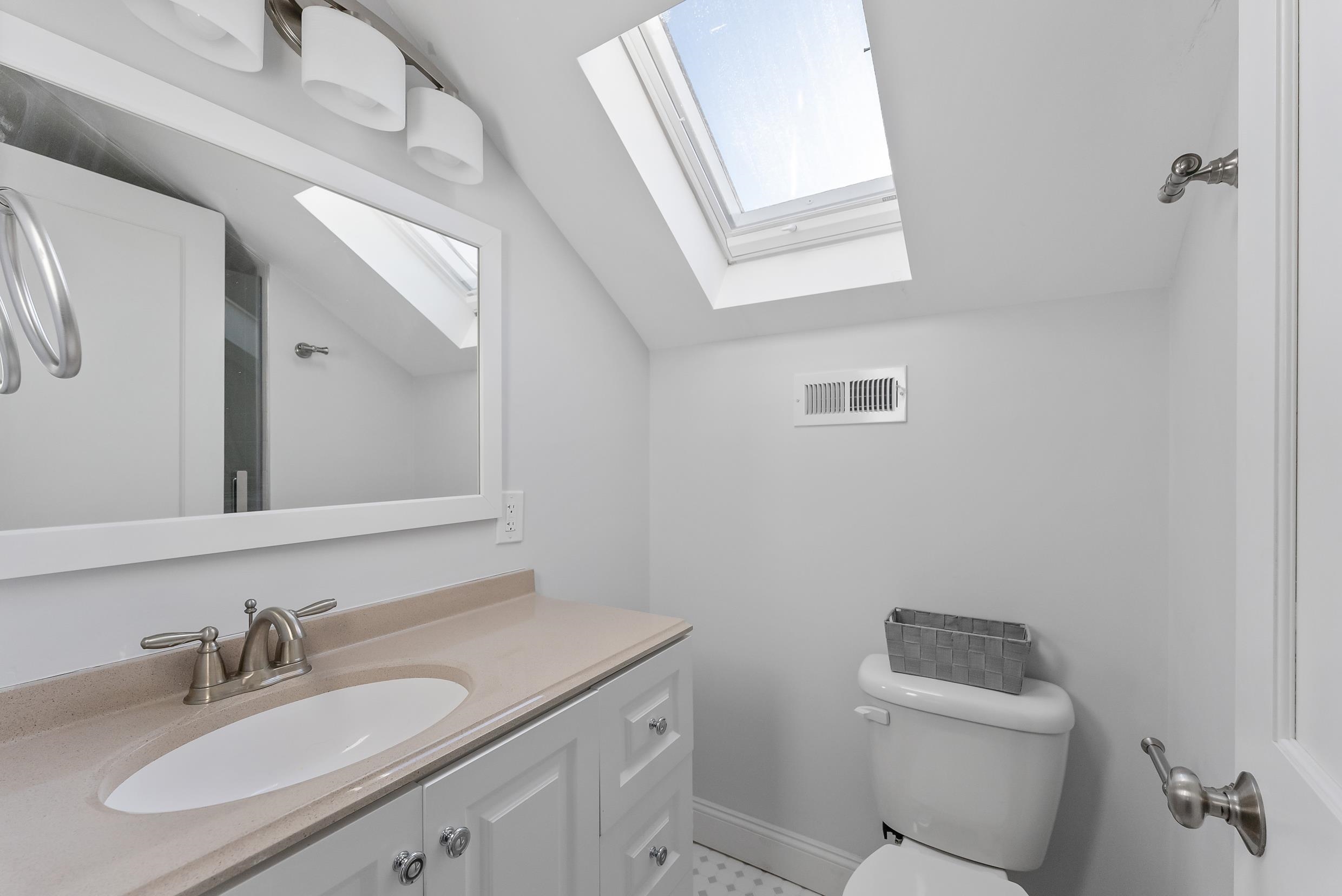 274 52nd Street Avalon, NJ 08202 - Photo 34 of 39 a bathroom with a sink toilet and a mirror