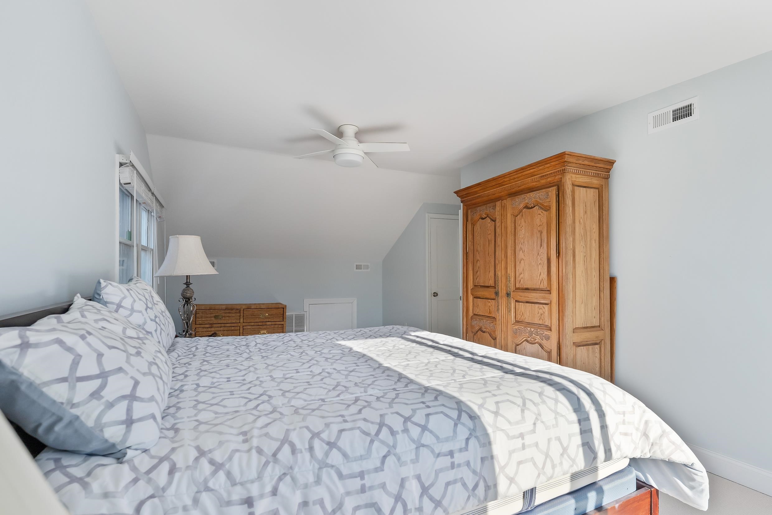 274 52nd Street Avalon, NJ 08202 - Photo 35 of 39 a bedroom with a large bed and a window