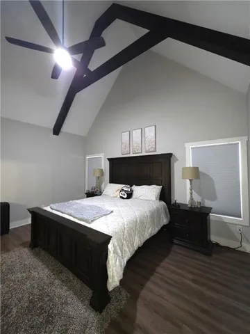 a bedroom with a bed and a television