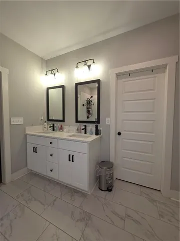 a spacious bathroom with a double vanity sink and a shower