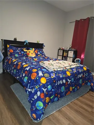 a bedroom with a bed and dresser