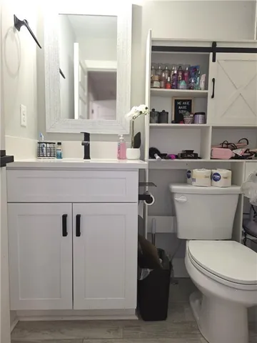 a white toilet sitting next to a bathroom sink