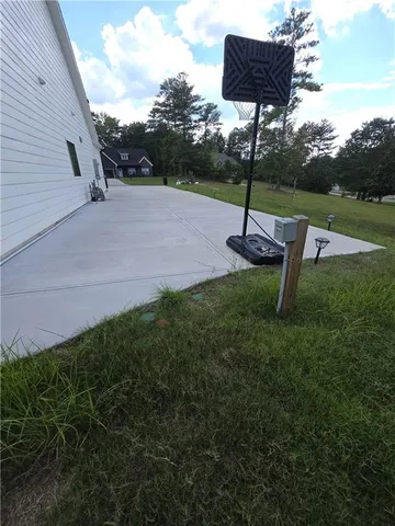 a backyard of a house with table and chairs
