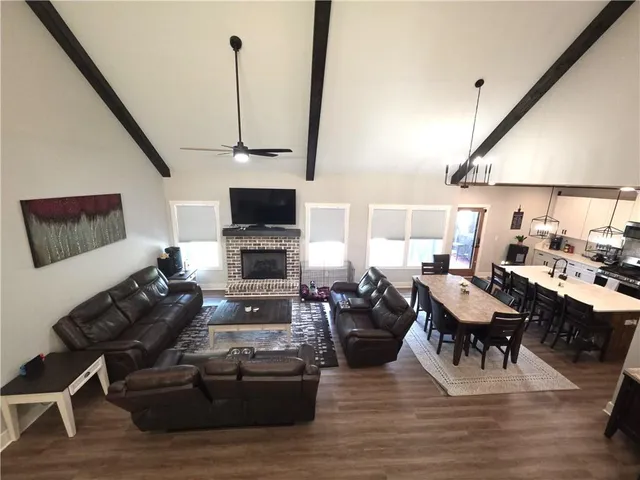 a living room with furniture a rug and a flat screen tv