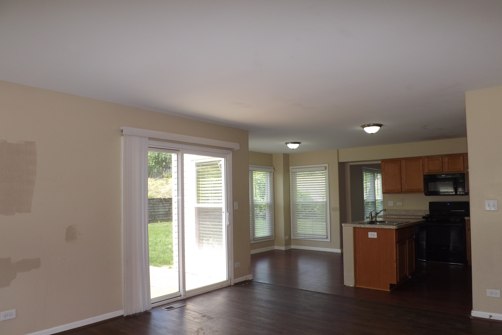 120 Arquilla Drive Algonquin, IL 60102 - Photo 7 of 18 wooden floor in an empty room with a kitchen