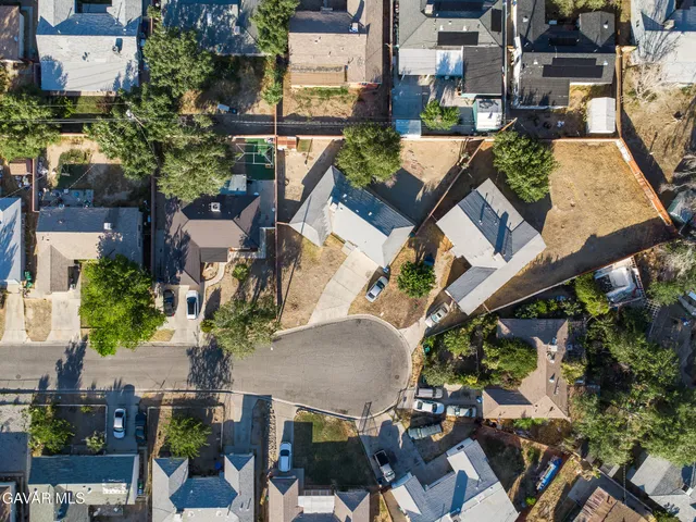 an aerial view of a house with a yard and garden