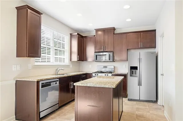 a kitchen with a sink stove and refrigerator