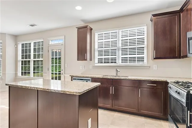 a kitchen with a sink stove and cabinets