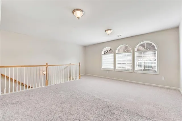 a view of a livingroom with a ceiling fan and window