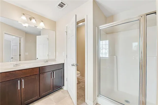 a bathroom with a tub a sink and mirror
