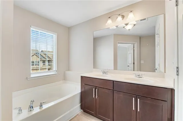 a bathroom with a double vanity sink mirror and