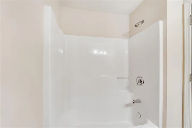 a front view of a house with a yard and potted plants