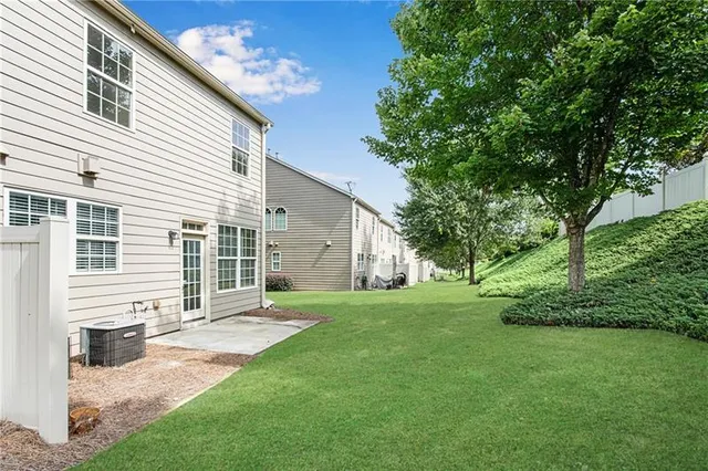 a view of a house with a yard and a large window