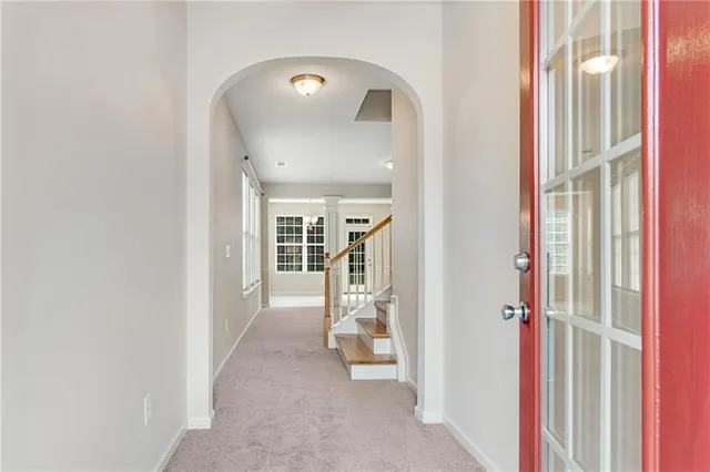 a view of a hallway with wooden cabinets and entryway
