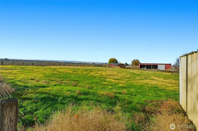 a view of a large body of water with a house in the background