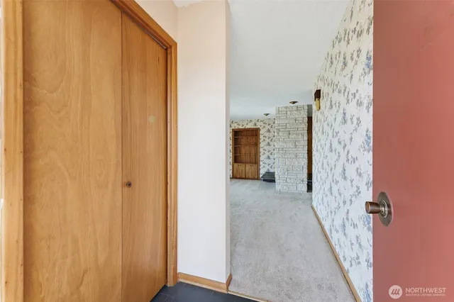 an empty room with a fireplace and large window