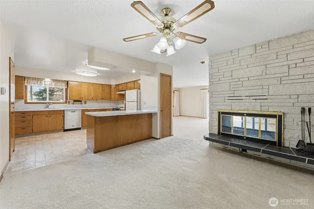 a kitchen with stainless steel appliances granite countertop a stove a sink and a refrigerator