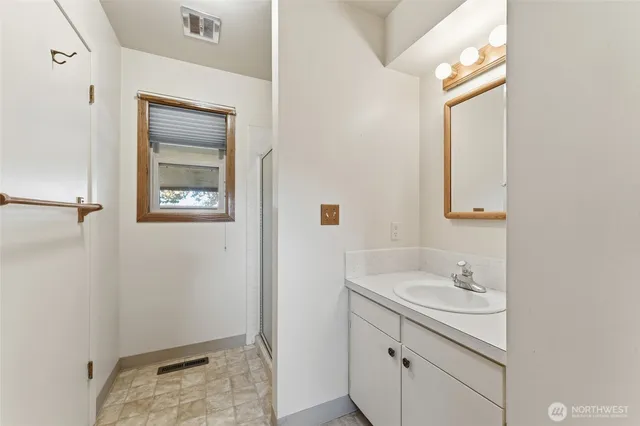 a view of a hallway with a chandelier fan