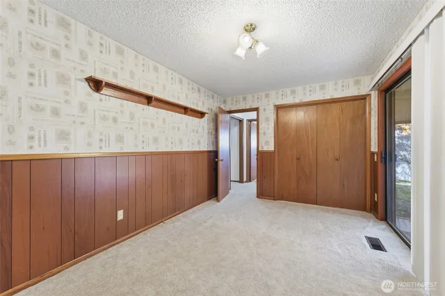 wooden floor in an empty room with a bathroom