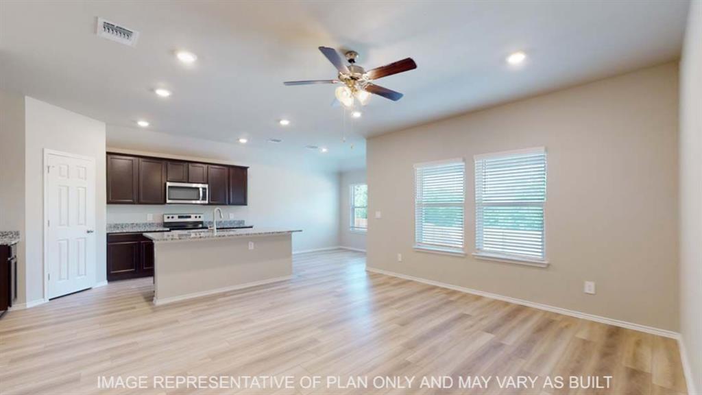 10429 Neptune Court Waco, TX 76708 - Photo 7 of 16 Wood-finish flooring, recessed lighting, and a ceiling fan enhance the living area