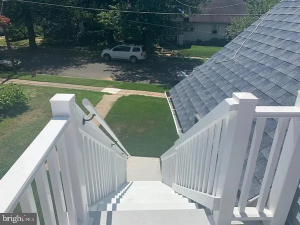 a view of a wooden deck and a patio with swimming pool