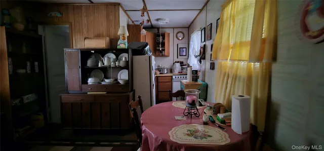 a view of a dining room with a table and chairs