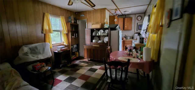 a room with lots of wooden furniture and a window