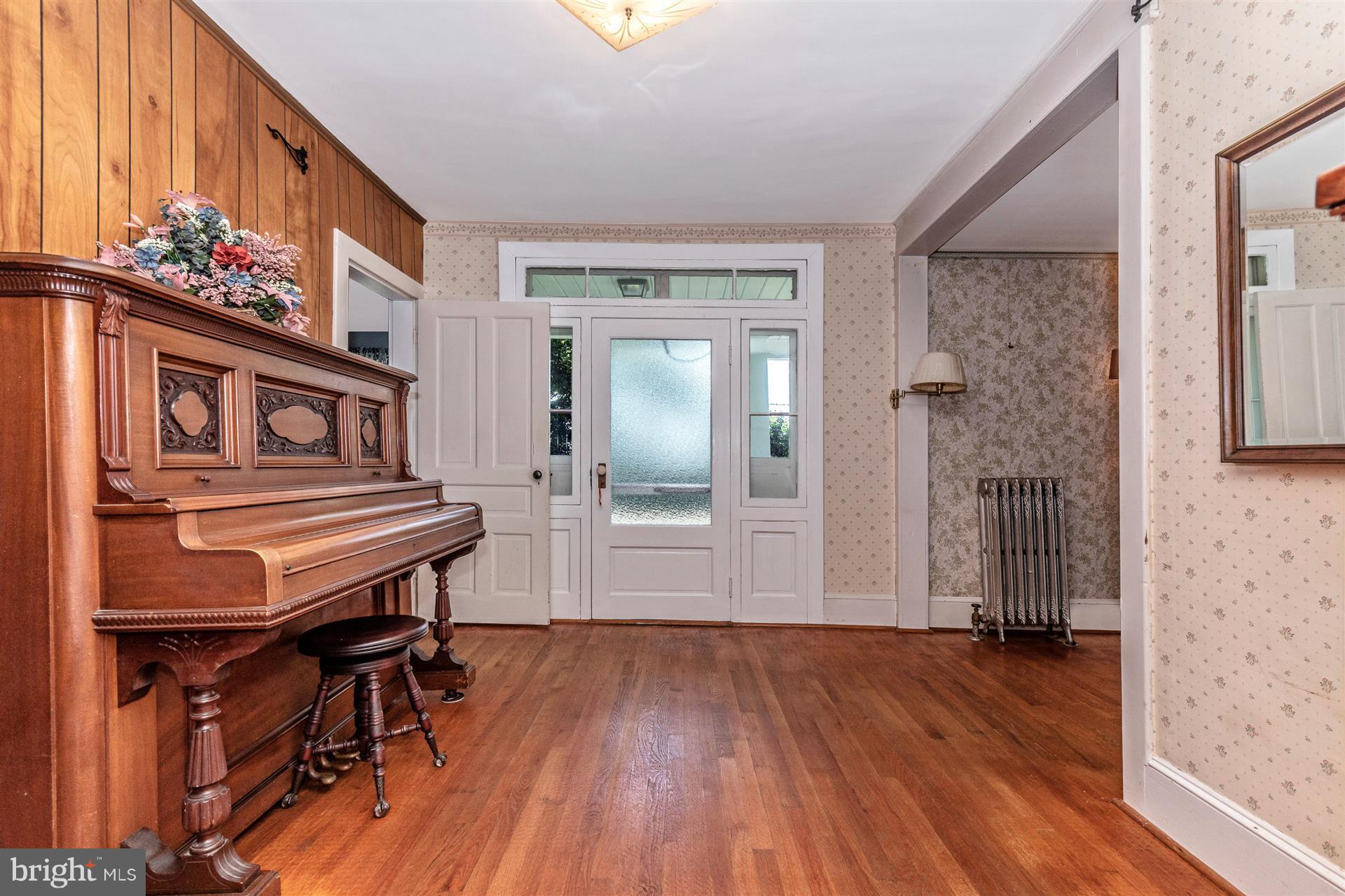 Foyer has lovely sidelights and transom windows.