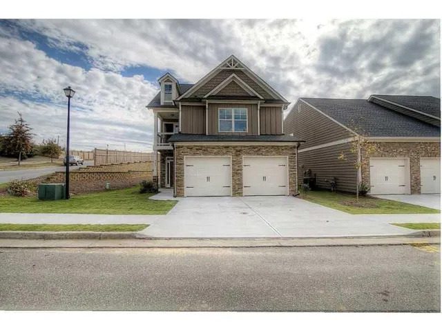 a view of a house next to a yard and road