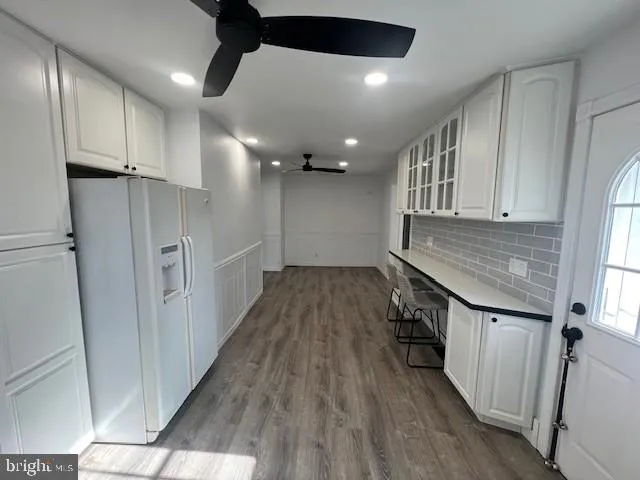 a view of a livingroom with wooden floor and staircase