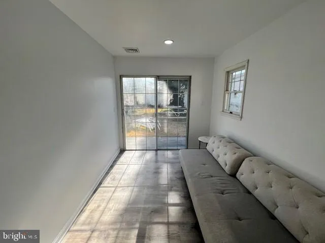 a living room with furniture and large window