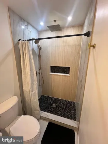 a bathroom with a toilet a sink and shower