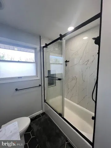 a bathroom with a shower and a toilet