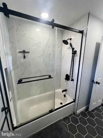 a bathroom with a shower and a glass door