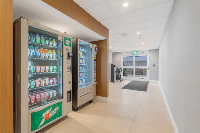 a room with lots of books and a large window