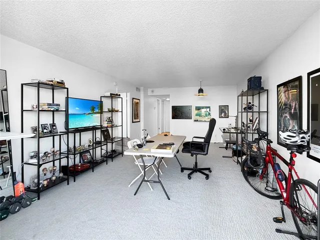 a view of a livingroom with furniture and a window
