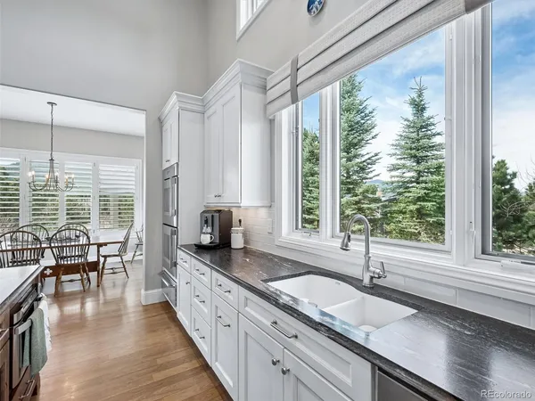 a kitchen with granite countertop a sink and a window