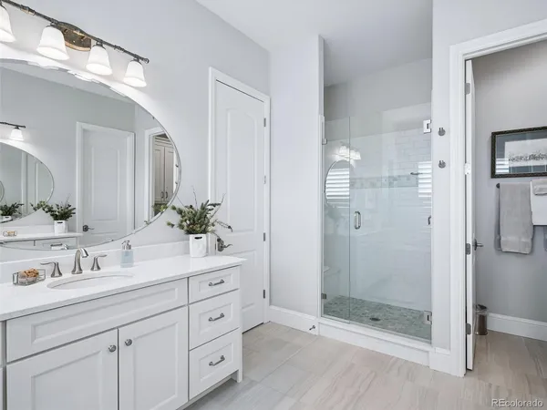 a bathroom with a shower sink and mirror