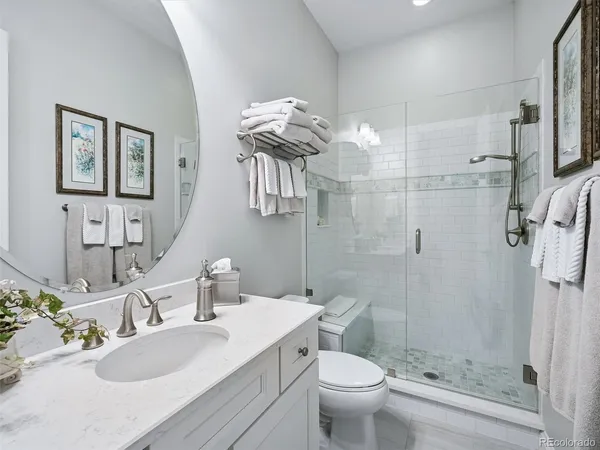 a bathroom with a sink toilet a mirror and shower