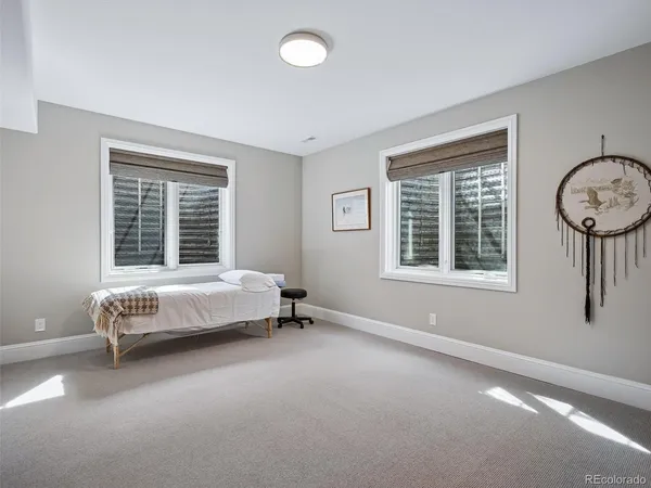 a bed sitting in a bedroom next to a window
