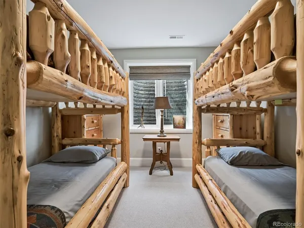 a bedroom with furniture and a large window