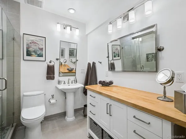 a spacious bathroom with a toilet sink and mirror