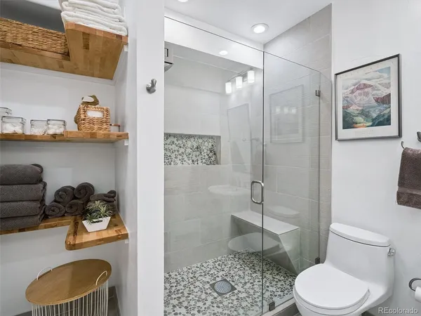 a bathroom with a toilet a sink and shower