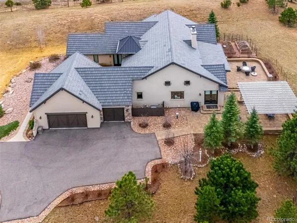 an aerial view of a house with outdoor space