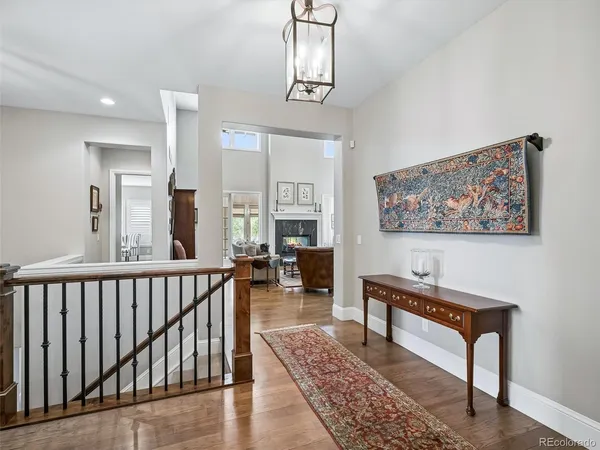 a living room with furniture a rug and a chandelier