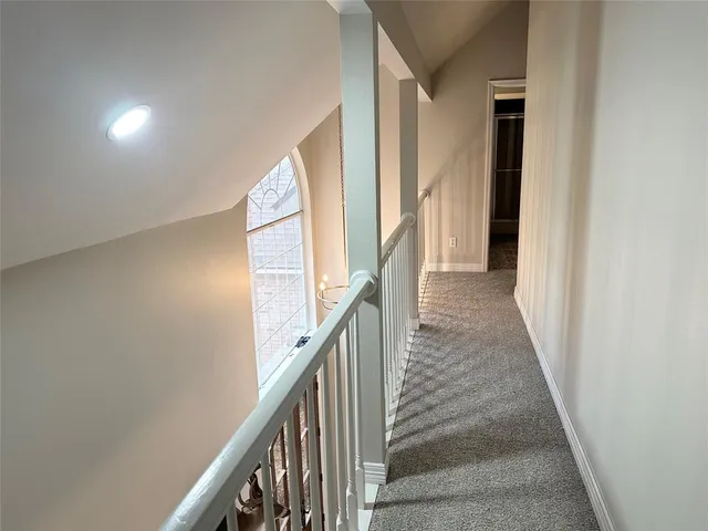 a view of a hallway with stairs