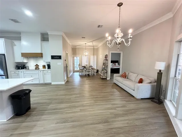 a view of a living room kitchen and a wooden floor