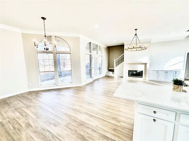 a view of a room with wooden floor and door