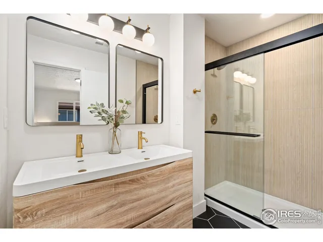 a bathroom with a sink a mirror and shower